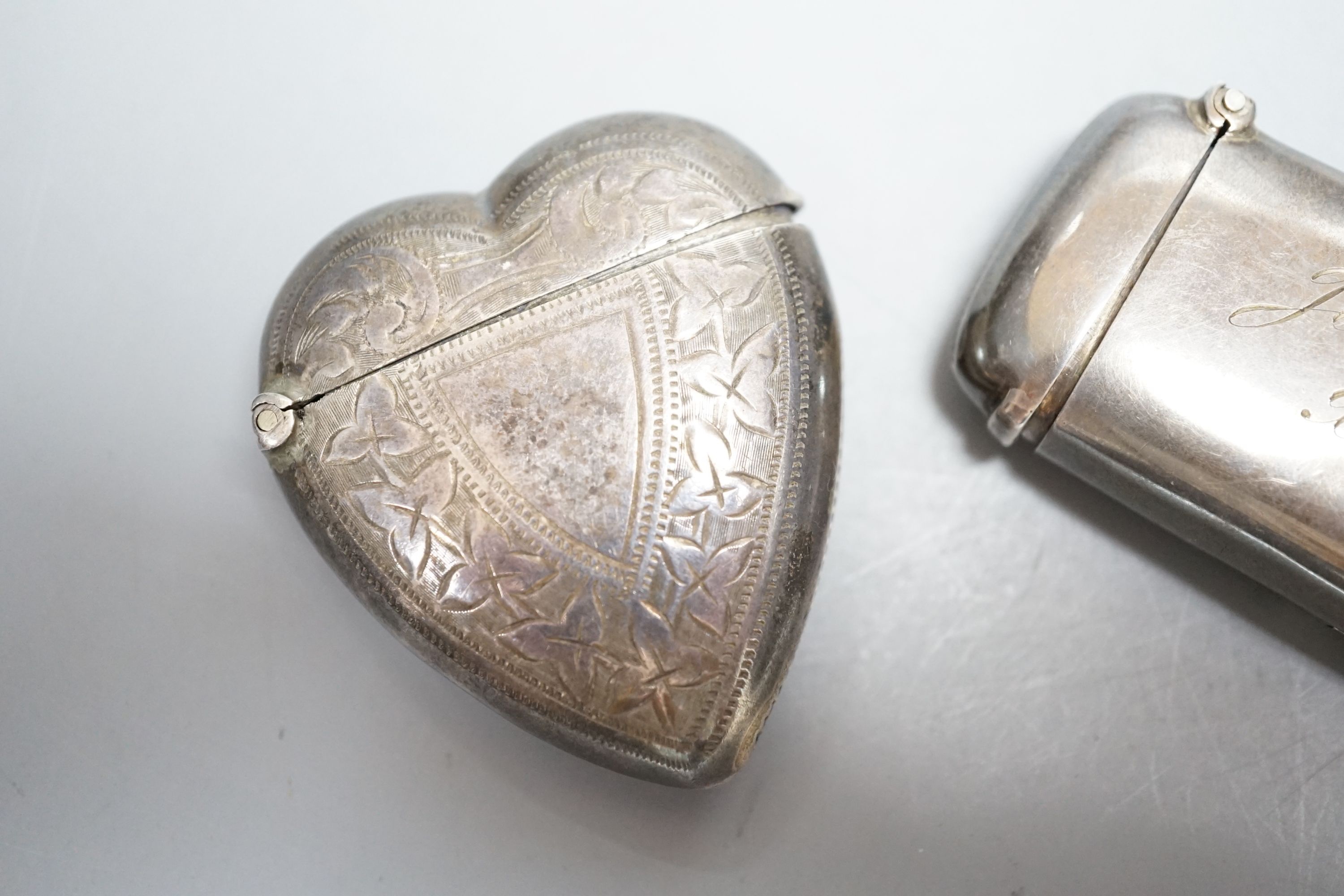 An Edwardian silver combination sovereign and vesta case, Robert Pringle & Sons, Birmingham, 1907, 62mm, with engraved inscription and a later Victorian silver heart shaped vesta case, Birmingham, 1897.